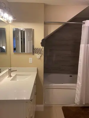 a bathroom with a sink and a mirror at 4 Bedroom 3 Bathroom Villas At SevenDwarfs 20-102 in Kissimmee