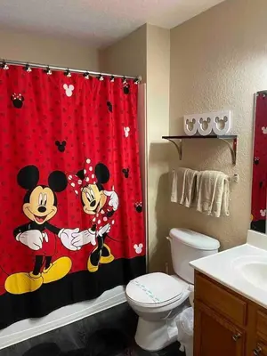 a bathroom with a mickey mouse shower curtain at 4 Bedroom 3 Bathroom Villas At SevenDwarfs 20-102 in Kissimmee