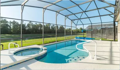 a large swimming pool with a glass roof at Emerald Island Getaway – Sleeps 13! in Kissimmee