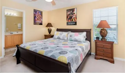 a bedroom with a bed and a sink and a mirror at Emerald Island Getaway – Sleeps 13! in Kissimmee