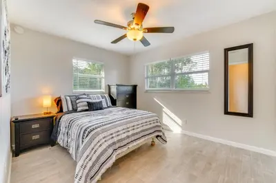 a bedroom with a bed and a ceiling fan at Nature-Packed Family Escape Near Lake Tohopekaliga in Kissimmee