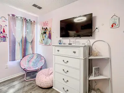 a room with a white dresser and a tv at Hogwarts Escape: Magical Retreat Near Disney in Kissimmee