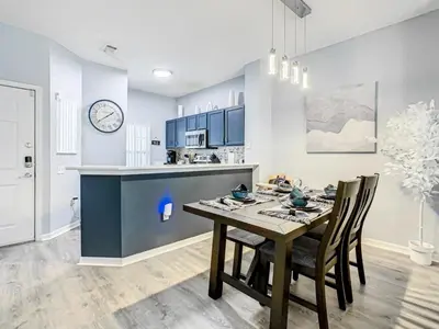 a kitchen and dining room with a table and chairs at Hogwarts Escape: Magical Retreat Near Disney in Kissimmee