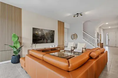 a living room with a brown leather couch at Paradiso Grande Resort 9Bedroom Vacation Home 6210 in Orlando
