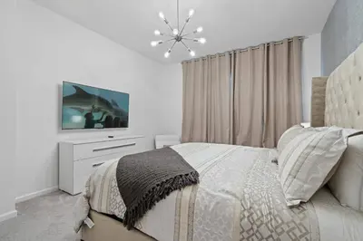a white bedroom with a bed and a tv at Paradiso Grande Resort 9Bedroom Vacation Home 6210 in Orlando