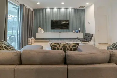 a living room with a couch and a tv at Mario Bros Game room 8BD Pool Movie Room 2622 in Kissimmee