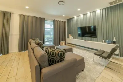 a living room with a couch and a flat screen tv at Mario Bros Game room 8BD Pool Movie Room 2622 in Kissimmee