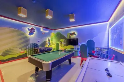 a room with a pool table in a room with a mural at Mario Bros Game room 8BD Pool Movie Room 2622 in Kissimmee