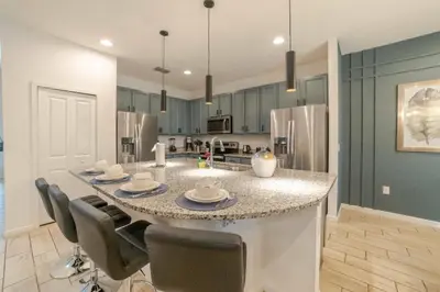 a kitchen with a large island with chairs around it at Mario Bros Game room 8BD Pool Movie Room 2622 in Kissimmee