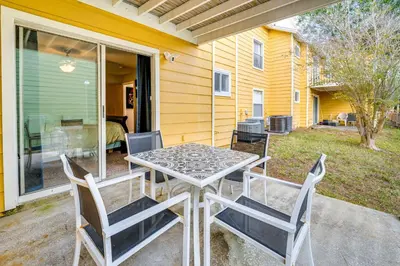 a table and chairs on the patio of a house at 7 Mi to Disney Condo with Pool and Hot Tub Access! in Kissimmee