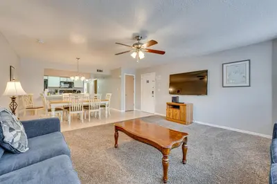 a living room with a couch and a table at 7 Mi to Disney Condo with Pool and Hot Tub Access! in Kissimmee