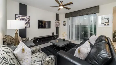 a living room with a leather couch and a table at CTD4741-102 in Kissimmee
