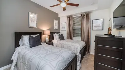 a bedroom with two beds and a ceiling fan at CTD4741-102 in Kissimmee