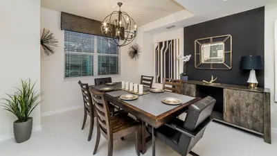 a dining room with a wooden table and chairs at CTD4741-102 in Kissimmee