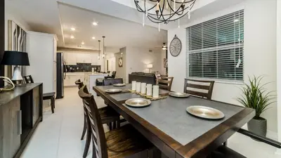 a dining room and kitchen with a table and chairs at CTD4741-102 in Kissimmee