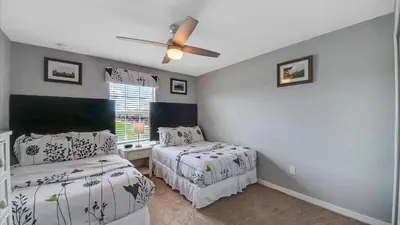 a bedroom with two beds and a ceiling fan at CUP8946 in Kissimmee