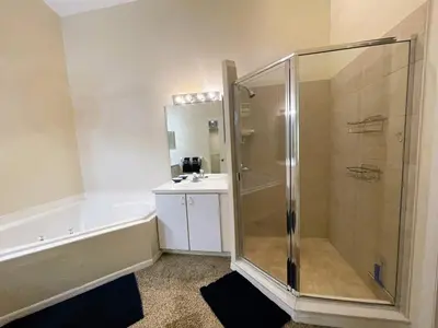 a bathroom with a shower and a tub and a sink at 2950 COTTAGE GROVE COURT ORLANDO 3BED in Orlando