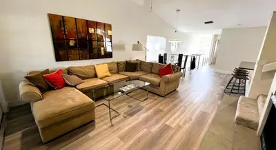 a living room with a couch and a table at 2971 COTTAGE GROVE COURT ORLANDO 3BED in Orlando