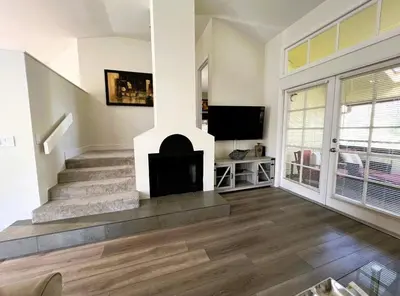 a living room with a fireplace and a staircase at 2971 COTTAGE GROVE COURT ORLANDO 3BED in Orlando
