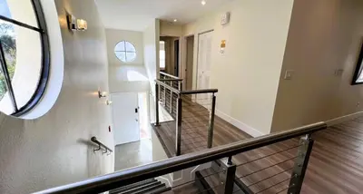 a hallway with a spiral staircase with a round window at 2971 COTTAGE GROVE COURT ORLANDO 3BED in Orlando