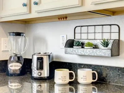 a kitchen counter with two coffee mugs and a blender at Luxury Townhome Near Disney w/ Resort Amenities in Orlando