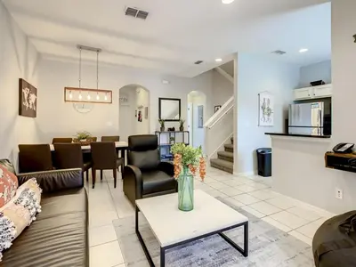 a living room with a couch and a table at Luxury Townhome Near Disney w/ Resort Amenities in Orlando