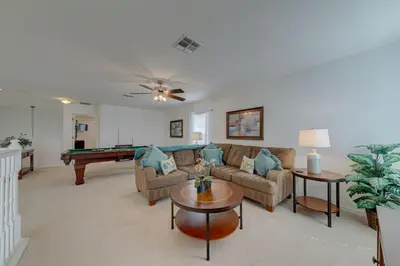 a living room with a couch and a pool table at 5 Bedroom private pool home in Veranda Palms in Kissimmee
