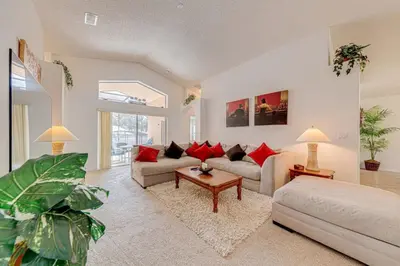 a living room with two couches and a table at Pool home close to Golfing and Theme parks in Orlando