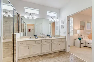 a bathroom with a double sink and a mirror at 6 Bed villa close to disney in Kissimmee