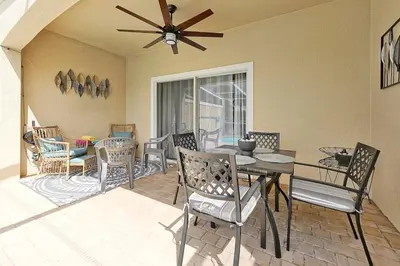 a dining room with a table and chairs at Magical serenity 3 bedroom pool home in Orlando