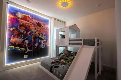 a bedroom with a bunk bed and a large painting at 5761 HS - Spacious Luxury Villa in Paradiso Grande in Orlando