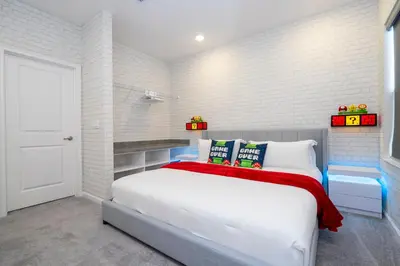 a white bedroom with a white brick wall at 5761 HS - Spacious Luxury Villa in Paradiso Grande in Orlando
