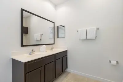 a bathroom with a sink and a mirror at Regal Oaks Retreat: Pool, Hot Tub & Near Disney in Kissimmee