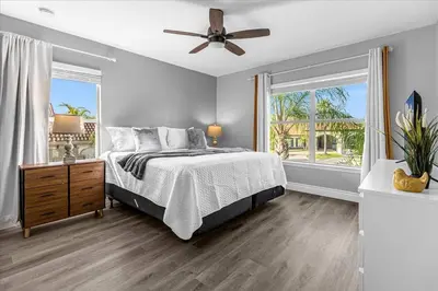 a bedroom with a bed and a ceiling fan at Spacious 7-Bedroom Home at Bella Vida Resort with Conservation View in Kissimmee