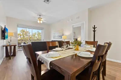 a dining room with a wooden table and chairs at ALM2774-403 in Orlando
