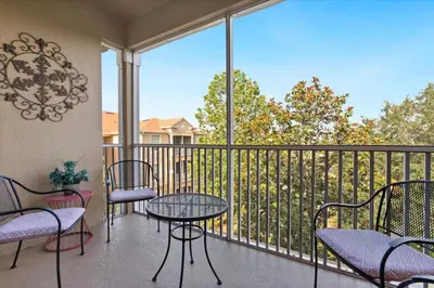 a balcony with tables and chairs and a balcony with a view at ALM2774-403 in Orlando