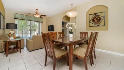 a dining room and living room with a table and chairs at ALM2781-103 in Orlando
