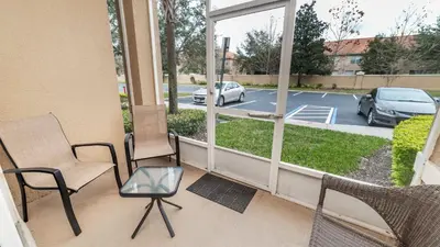 a balcony with chairs and a view of a parking lot at ALM2809-101 in Orlando