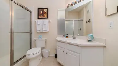 a white bathroom with a toilet and a sink at ALM2809-101 in Orlando