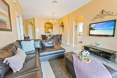 a living room with a leather couch and a television at ALM2813-403 in Orlando