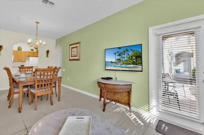 a dining room and living room with a table at ALM2821-104 in Orlando