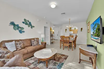 a living room with a couch and a table at ALM2821-104 in Orlando