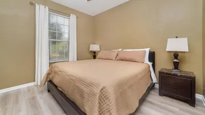 a bedroom with a large bed and a window at ALM2821-204 in Orlando