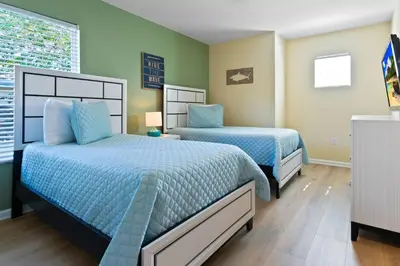 two beds in a bedroom with green walls at DVL2638 in Orlando