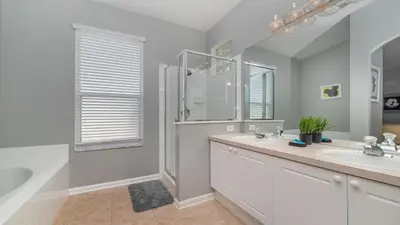 a bathroom with a shower and a sink and a tub at FP8208 Windsor Palms Resort Vacation Home in Kissimmee