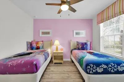 two beds in a room with purple walls at GRS7756 in Orlando