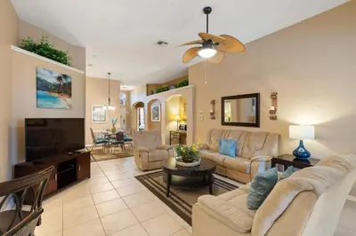 a living room with a couch and a flat screen tv at FP8104 Windsor Palms Resort Vacation Home in Kissimmee