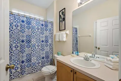 a bathroom with a sink and a toilet and a shower at FP8104 Windsor Palms Resort Vacation Home in Kissimmee