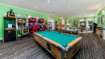 a games room with a pool table and arcade machines at FP8147 Windsor Palms Resort Vacation Home in Kissimmee