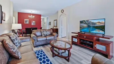 a living room with a couch and a tv at FP8159 Windsor Palms Resort Vacation Home in Kissimmee